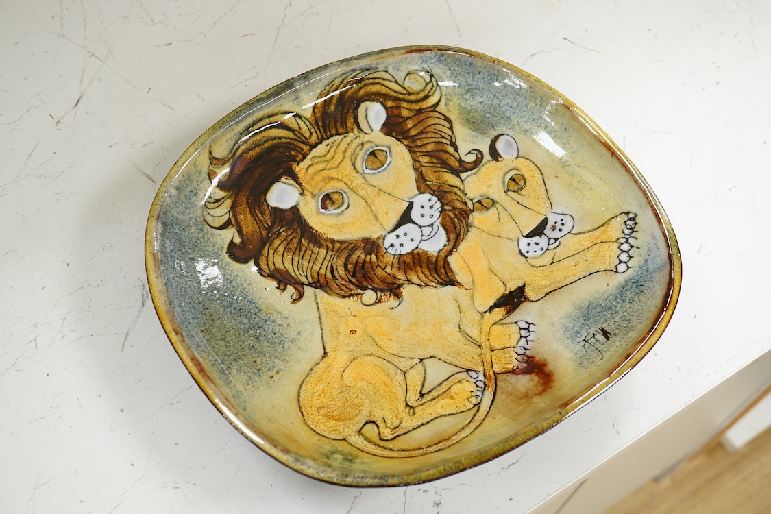 A Joyce Morgan, Chelsea pottery dish depicting a lion and lioness, monogrammed, stamped to the base, 27cm wide